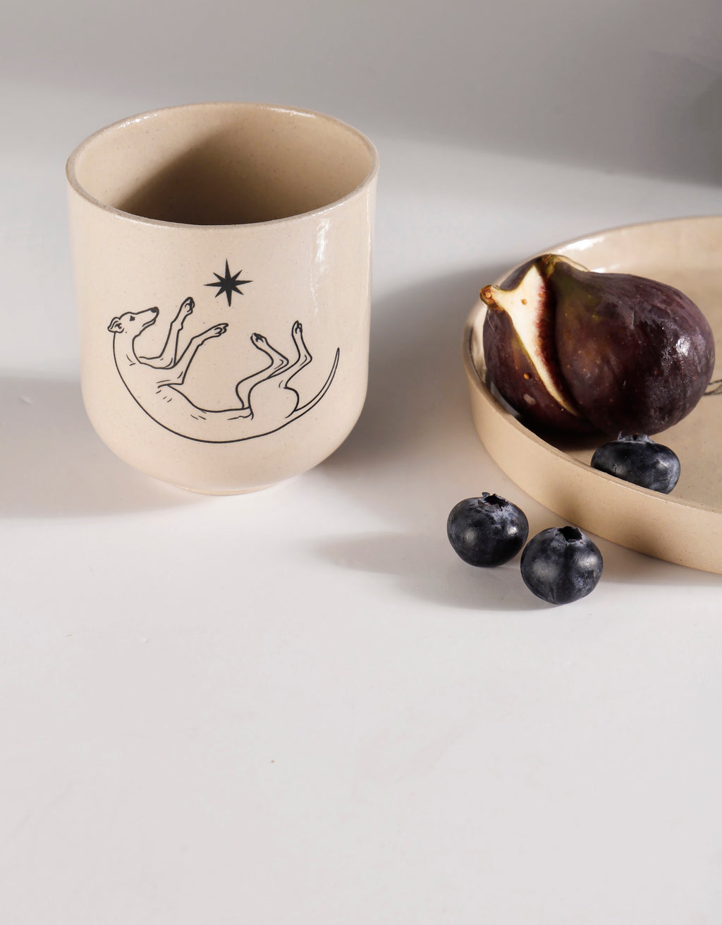 Handmade Black Roaching Greyhound Playing with a Star Ceramic Stoneware Handleless Cup