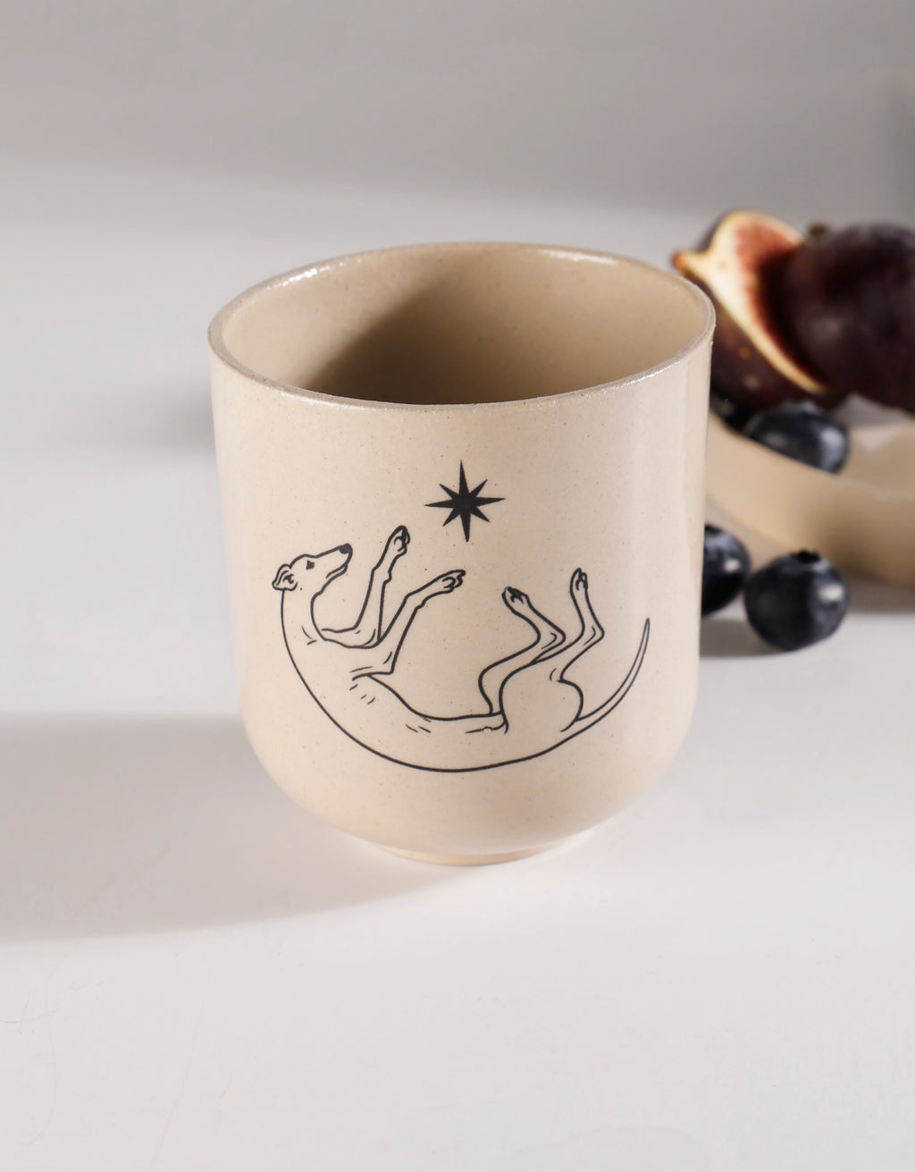 Handmade Black Roaching Greyhound Playing with a Star Ceramic Stoneware Handleless Cup